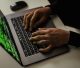 crop-cyber-spy-hacking-system-while-typing-on-laptop